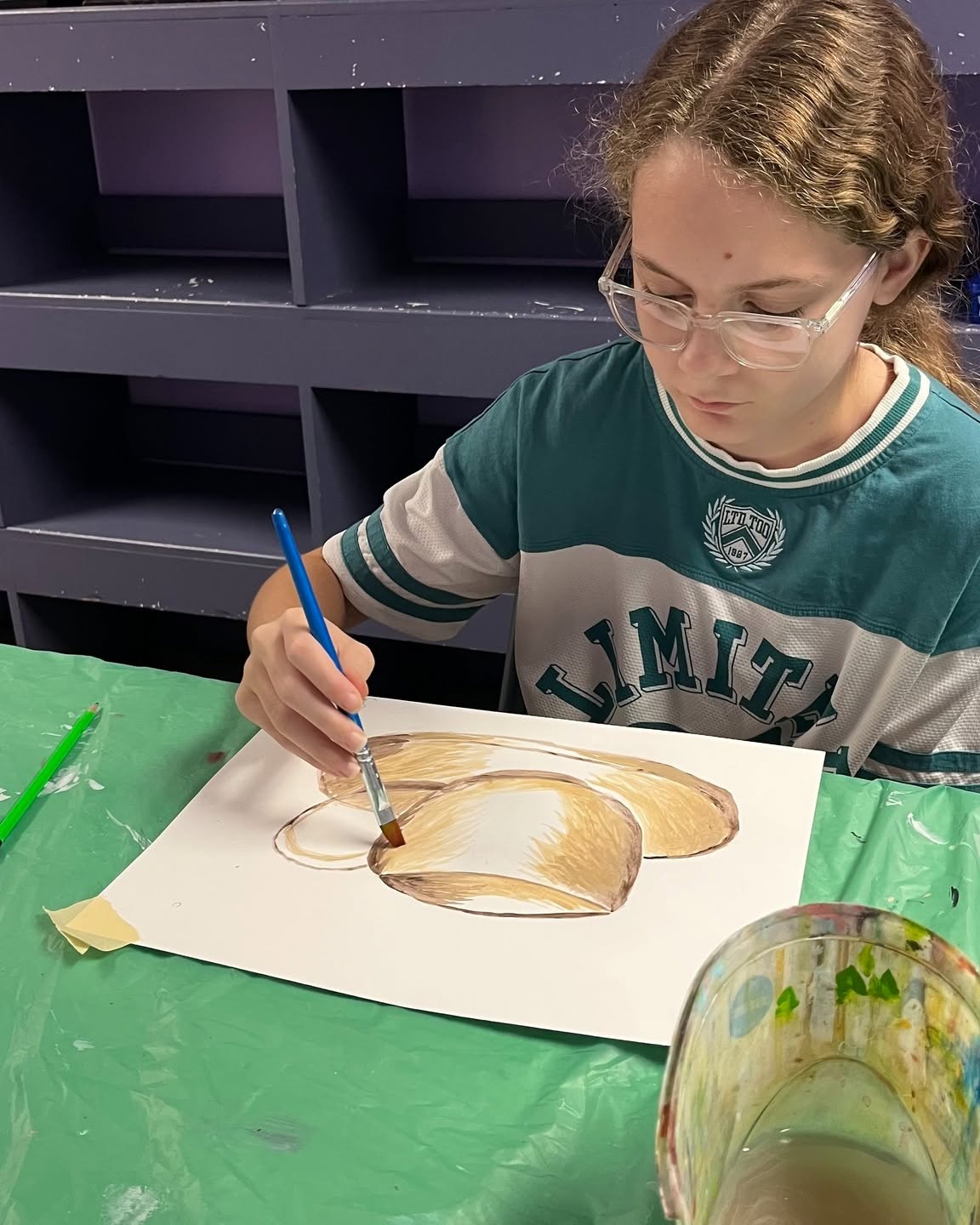 A student painting during Inspirations Academy art class