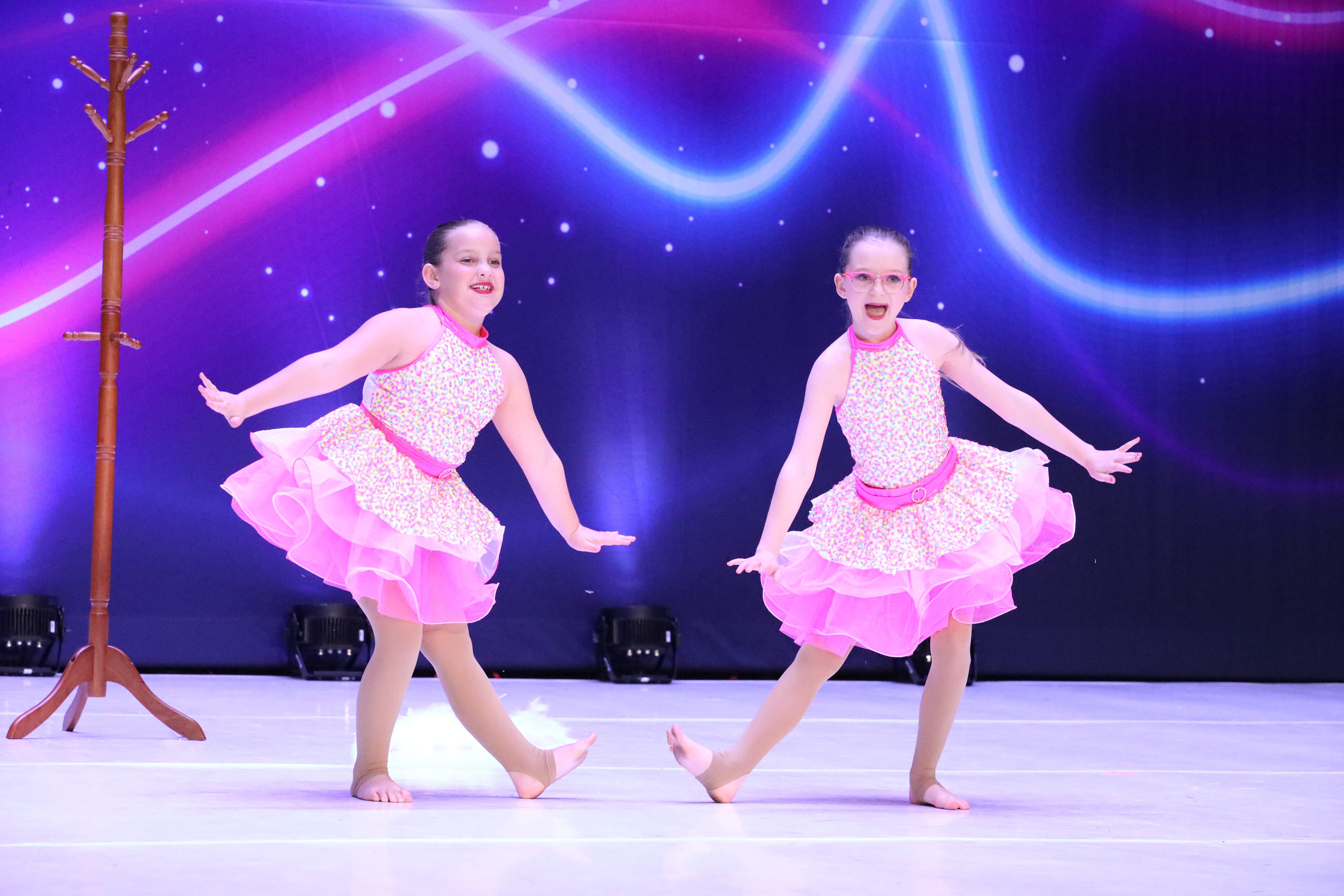 Two Inspirations Academy dancers performing on stage at a dance competition