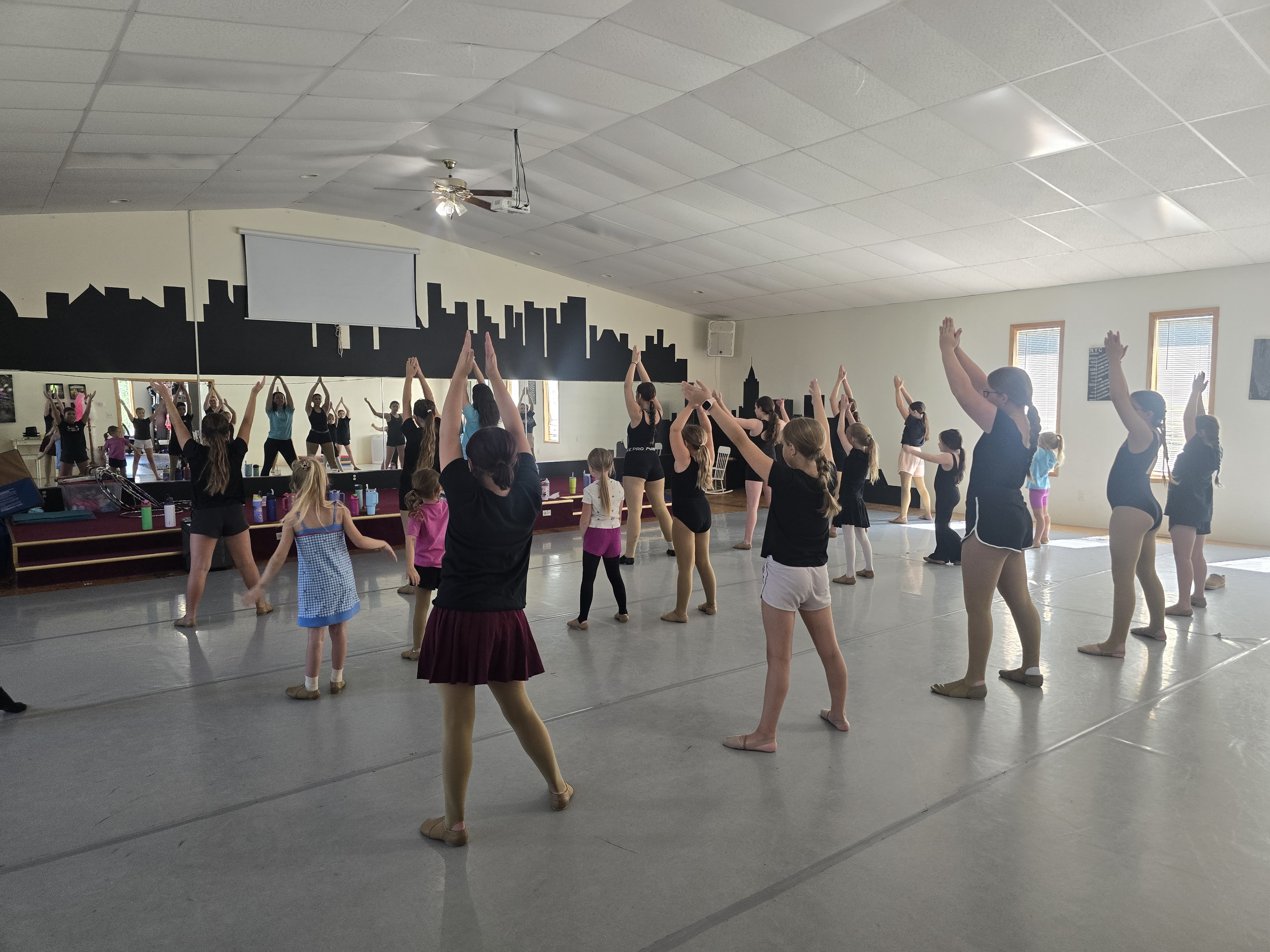 Students of different ages dancing together during a Summer at the Studio class.