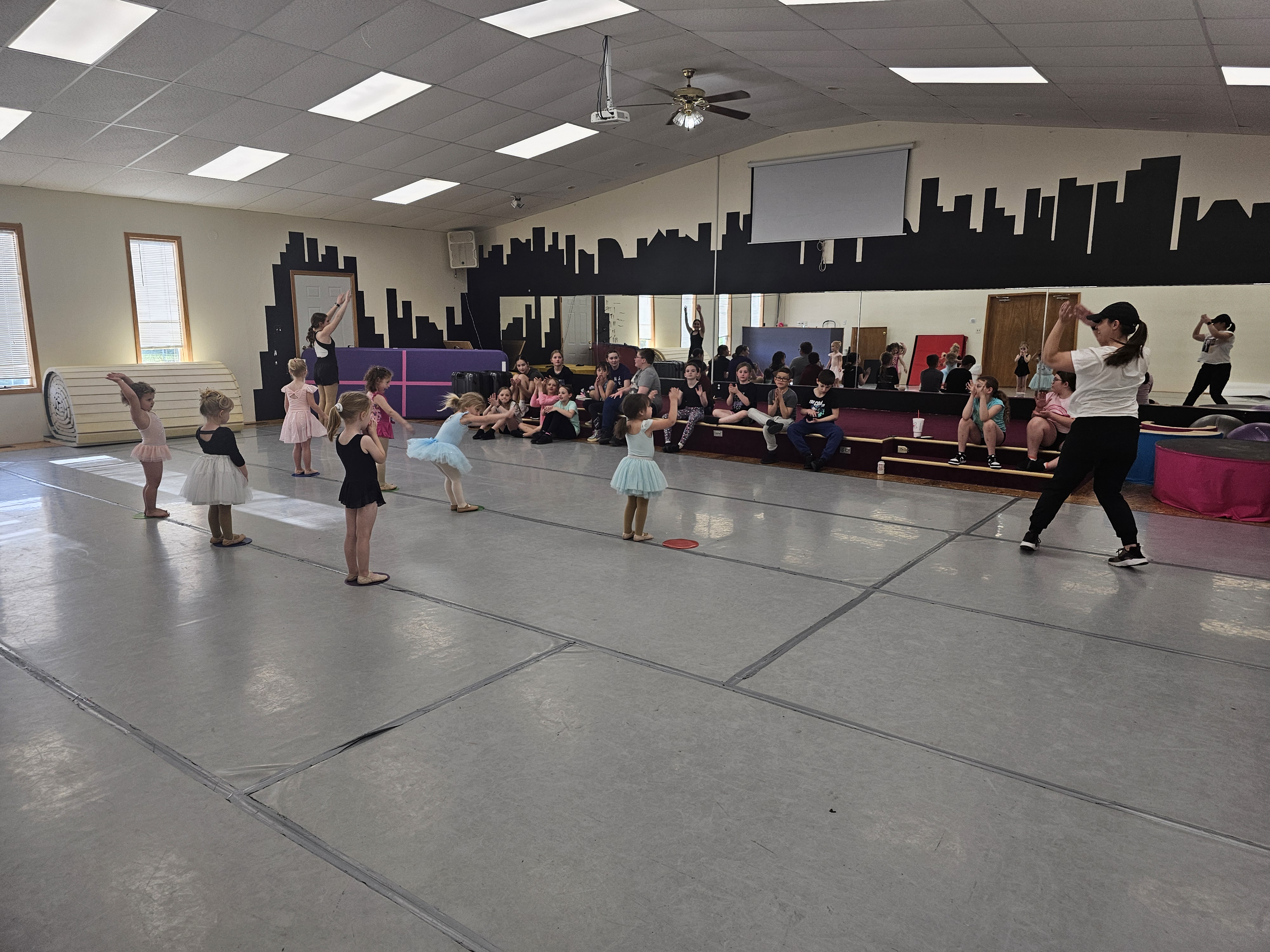 Little Dancers showing off what they learned to an audience of older students.