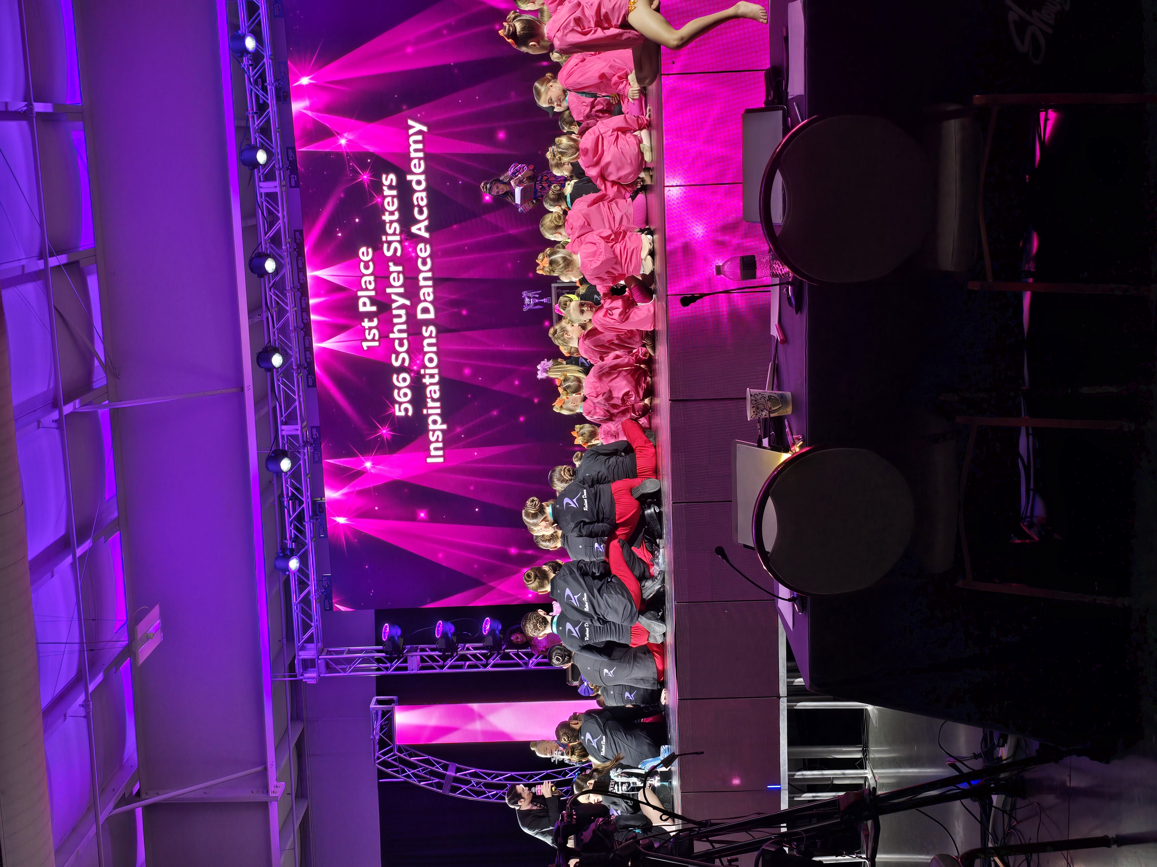 Inspirations Dance Academy named 1st place winners on stage at a dance competition.