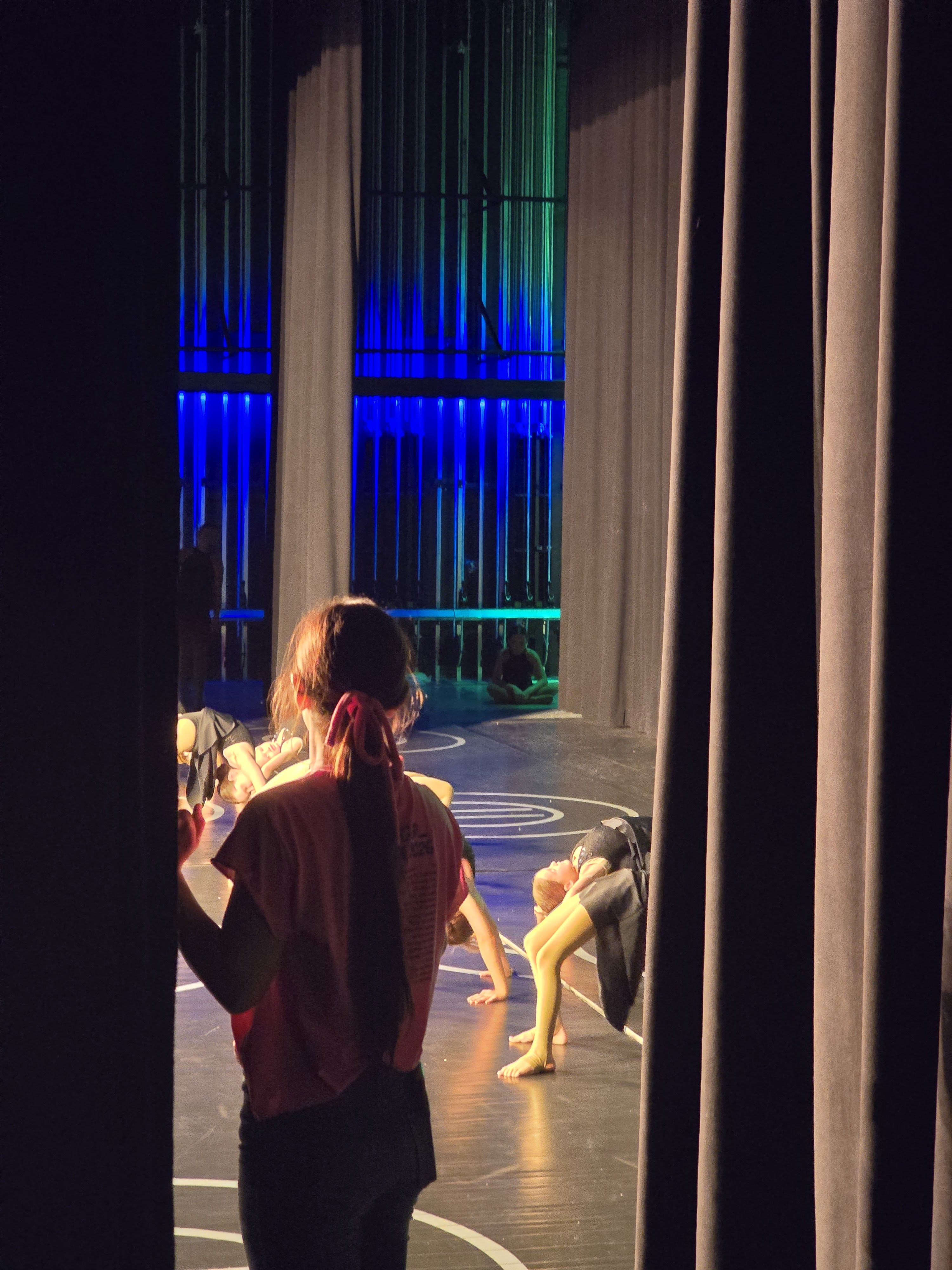 Miss Raychel cueing students from the wings before they take the stage at recital.