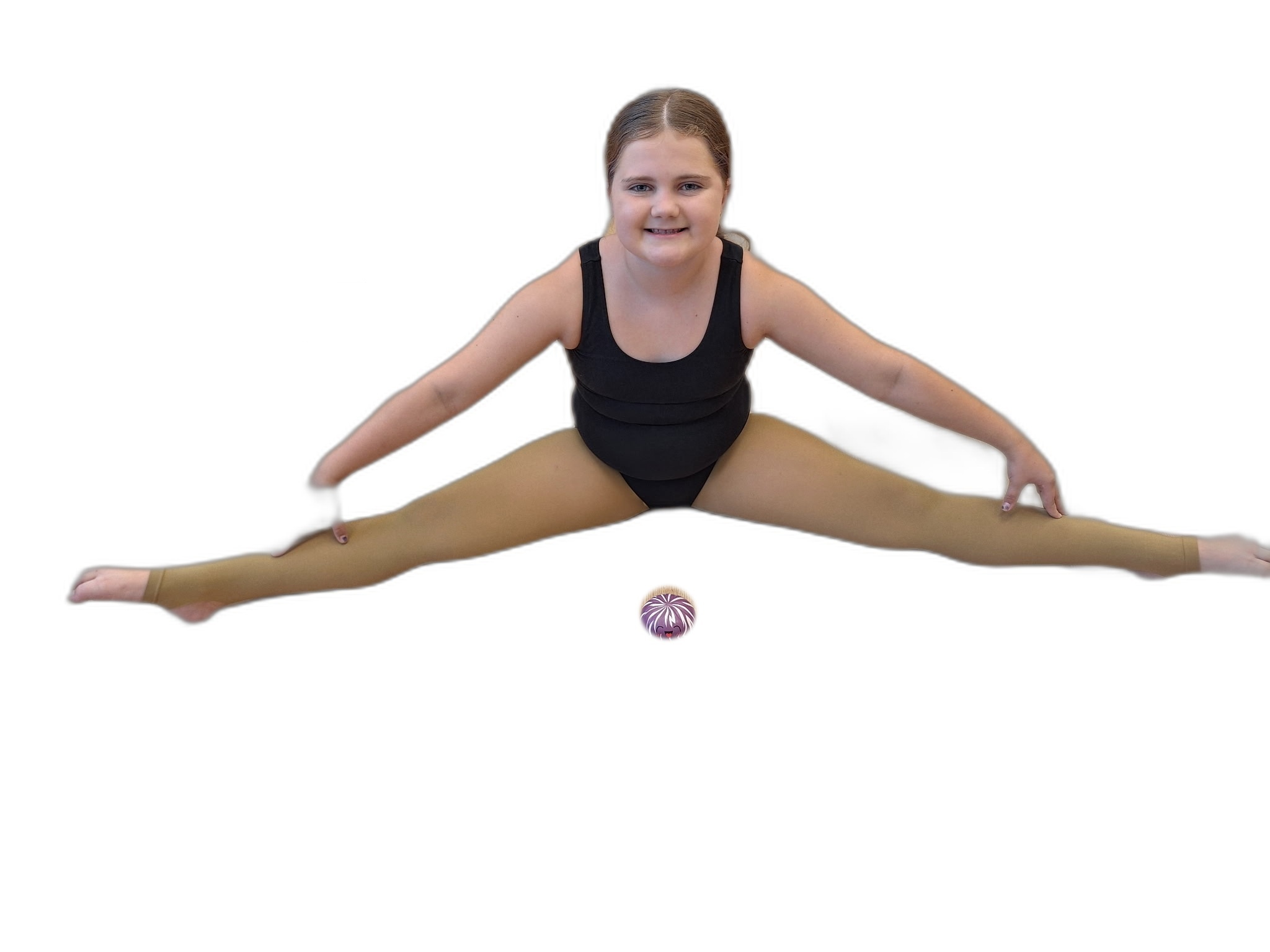 A student in a split with the Dancing With Dumplings plush toy on the floor in front of her.