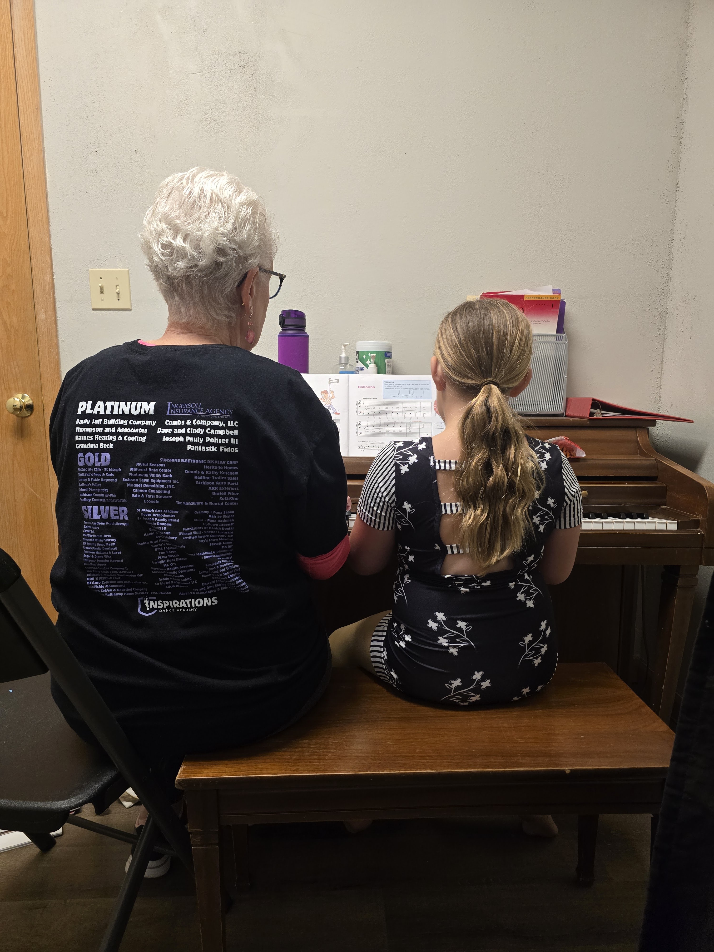 An instructor and student working together during a piano lesson.